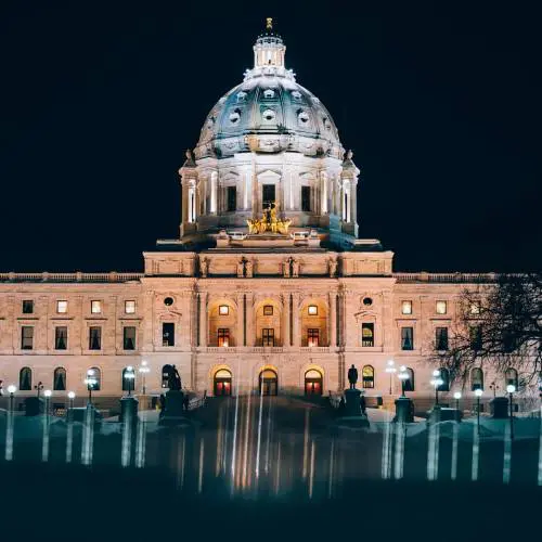 Illuminated domed building at night.