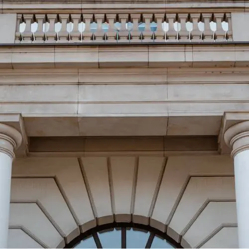 Elegant stone building facade with columns.